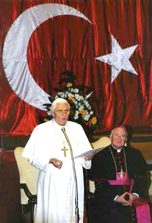 Benedict XVI speaking under the crescent of a Turkish flag